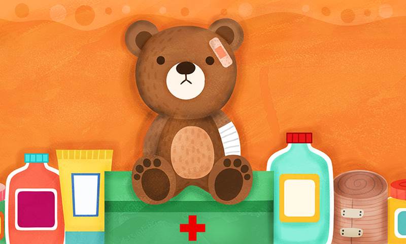 teddy bear with plaster on his head and a bandage wrapped around his arm. Next to him are various medicine bottles.