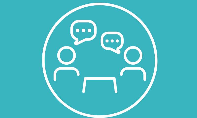 two people talking across a table 