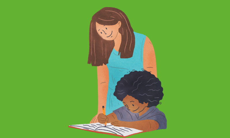 Image of a teacher assisting a student in a classroom