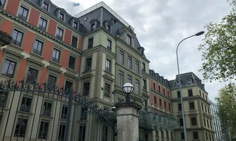 Photo shows Palais Wilson in Geneva where the UN Committee held the UK's child rights review. It is a tall, ornate building with orange and cream walls. It has lots of windows, pillars and a big security gate.