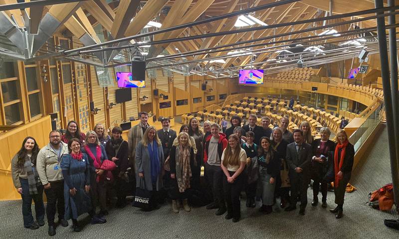 photo of children, young people and adult supporters celebrating in the Scottish Parliament