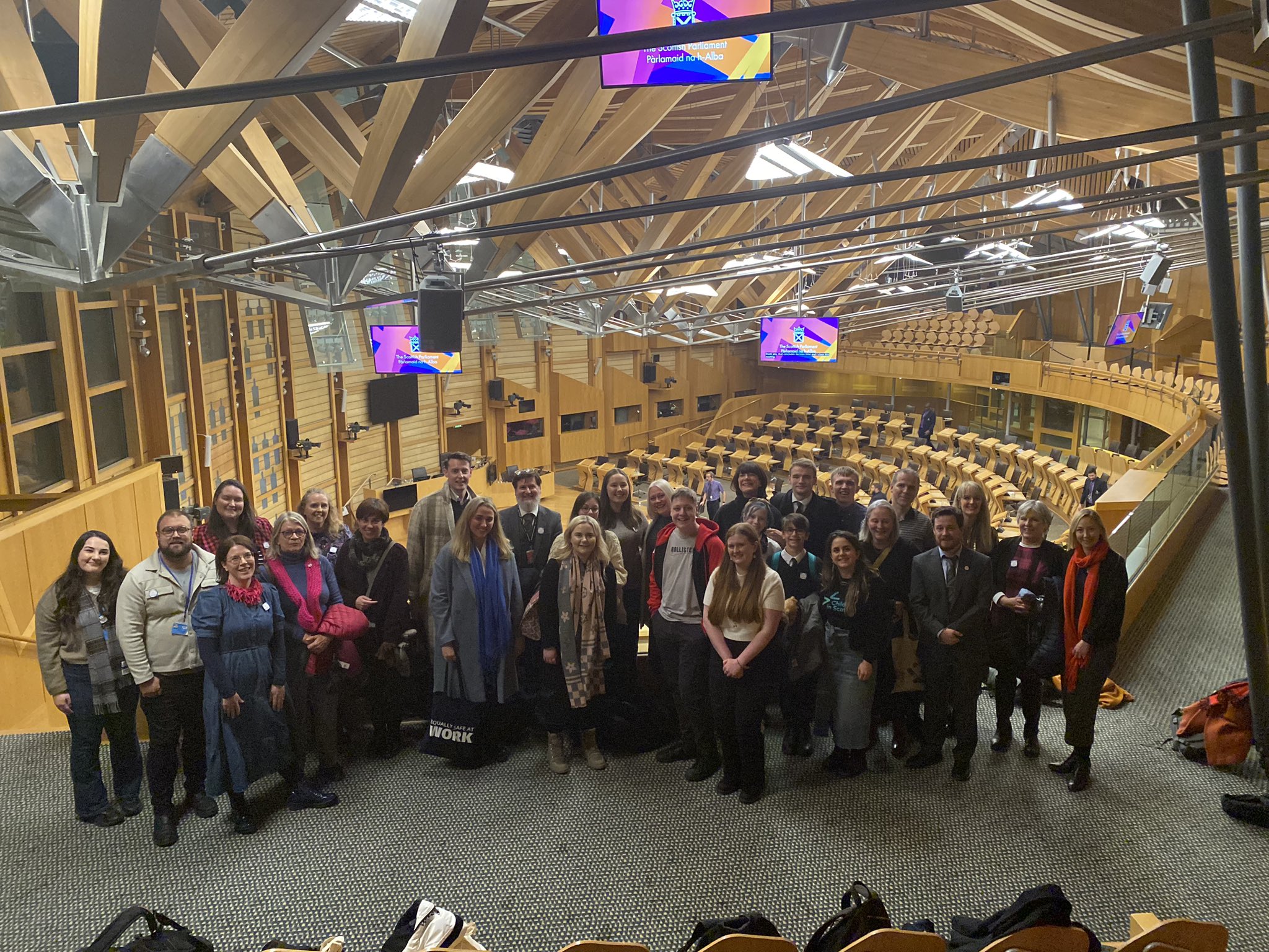 photo of children, young people and adult supporters celebrating in the Scottish Parliament