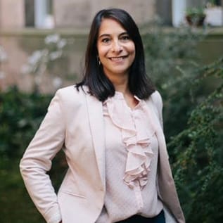 Photo of Cate with greenery in the background